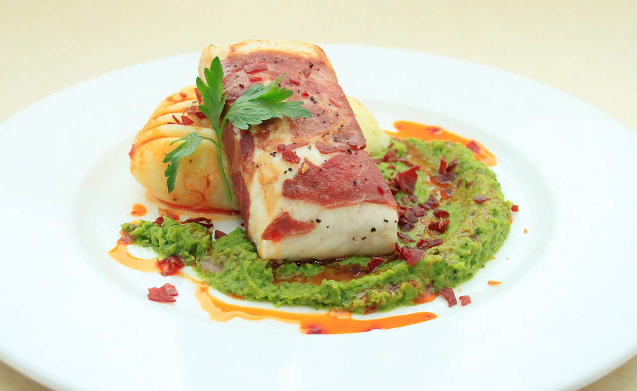 Hake with serrano ham mash & peas with red pepper oil